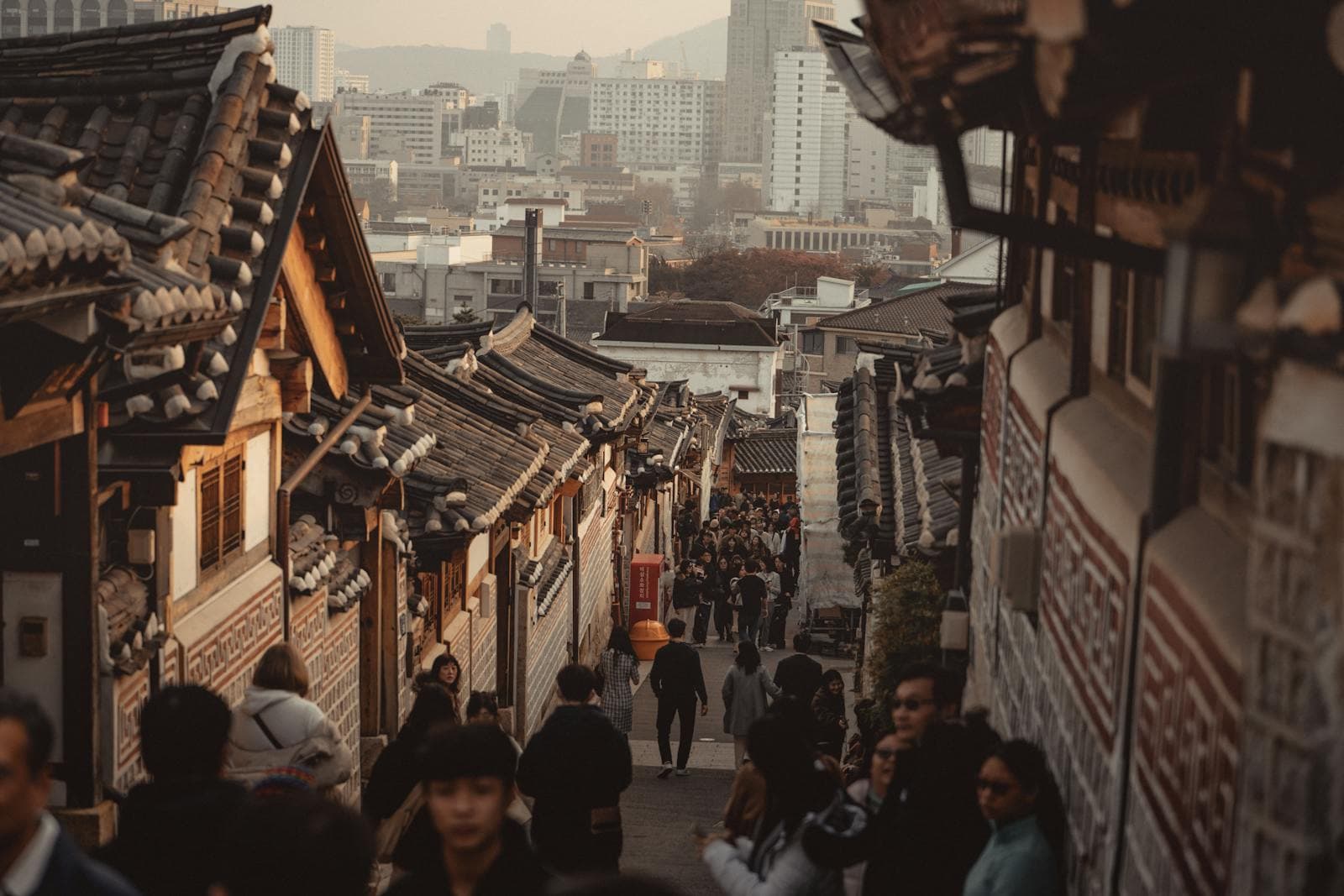 Lanterns hung above a Bukchon hanok village street at dusk
